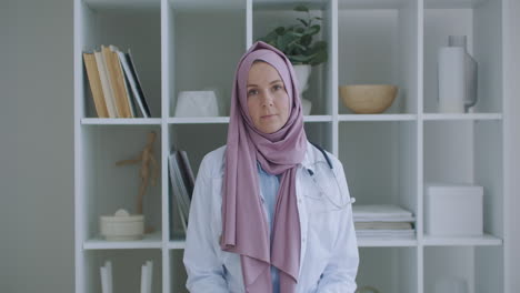Sie-Schaut-In-Die-Kamera-Und-Hört-Zu.-Eine-Ärztin-Im-Hijab-Blickt-In-Die-Kamera-Und-Hört-Dem-Patienten-Zu.-Ein-Zuhörer-Für-Videokonferenzen.-Porträt-Eines-Arztes-Im-Hijab